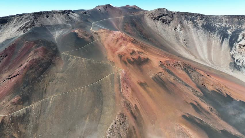 Haleakala Crater looms 10,023 feet above the Pacific Ocean, taking up three-quarters of Maui’s 727 square miles. Haleakala sunrise inspire 1.5 million visitors annually. Royalty-Free Stock Footage #3463397051