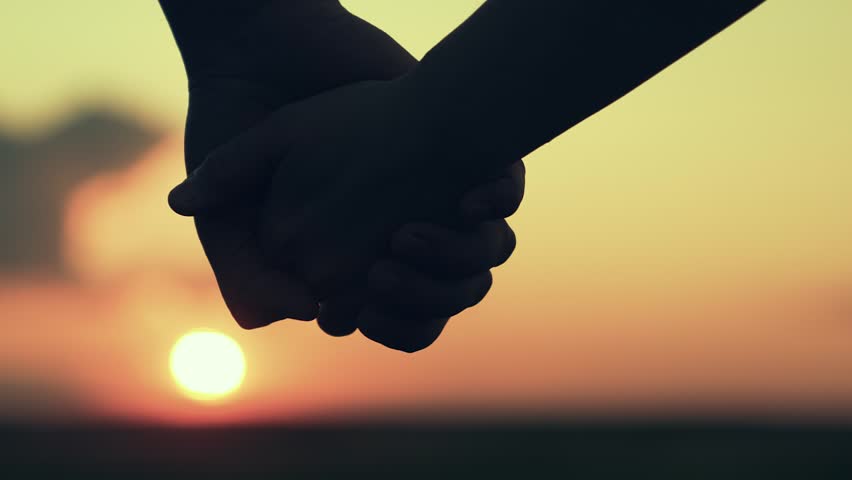 Separation of hands of man of woman. Family at sunset. Pair of man, woman separate their hands in front of sun. Closeup of guy lets go of girls hand, separation. Separation, separation, quarrel. Royalty-Free Stock Footage #3463427331