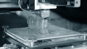 3D printer prints an object. The process of printing model on 3D printer. Model printed on 3D printer from molten plastic. 3D printing technologies. Additive progressive new modern printing technology - Powered by Shutterstock - Get 15% off with code: PIKWIZARD15