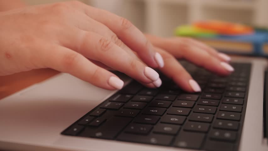 Woman typing on a keyboard laptop working at home. Modern laptop standing on the desk of the cozy home office. Royalty-Free Stock Footage #3463696271