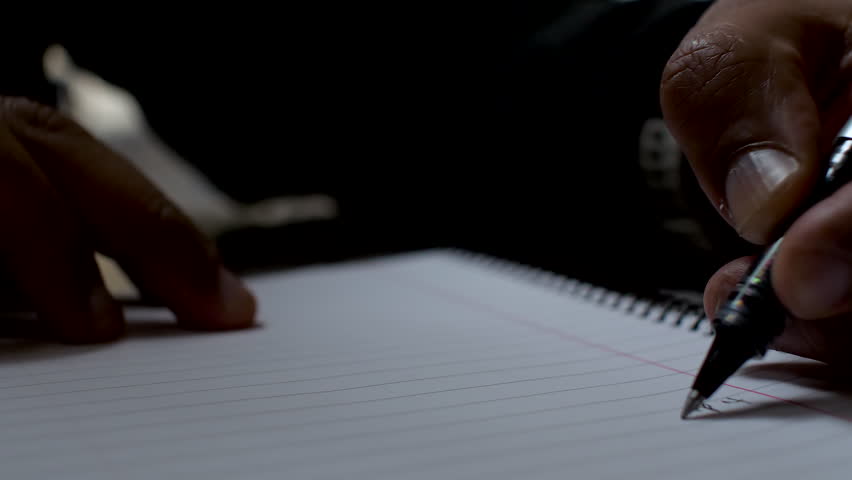 Close-up of a person writing on paper using a pen, creating a list with their left hand, highlighting the unique perspective of left-handed writing. Royalty-Free Stock Footage #3463747665