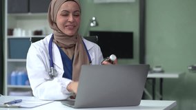 Caring Pharmacists or doctors conducts video consultation, communicates with patient via an online conference, uses laptop, diagnoses, recommended and prescribed medications, and also answers question