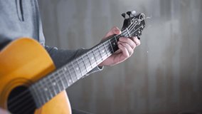 Guitarist plays on the acoustic western guitar with steel strings spanish random chords,exercises and arpeggios, video with sound, plaing the guitar, muscial instrument