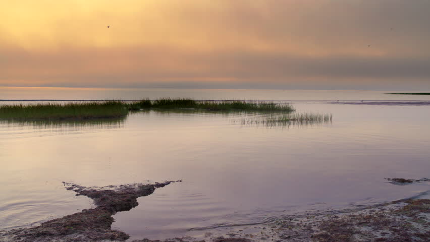 Sunset on Cape Cod\xD5s western shore with marshlands and foggy low cloud cover