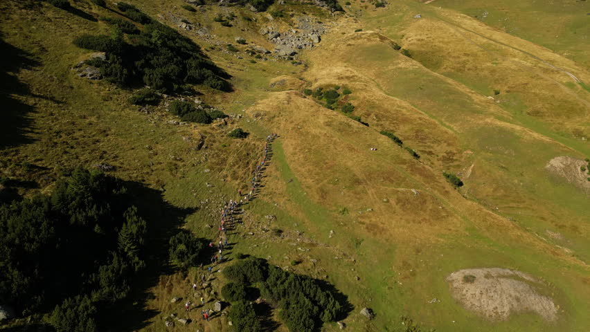 Aerial View of a Group of Hikers Walking on a Trail Path. Concept of healthy lifestyle, vacation activity, recreational pursuit, trekking, backpacking, hobby