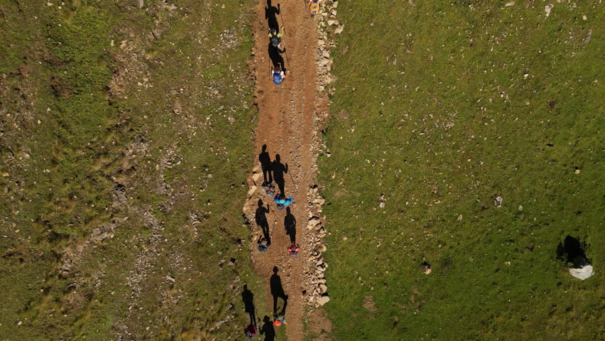 Top Down Shot of a Group of People Backpacking on a Trail Path. Concept of healthy lifestyle, vacation activity, recreational pursuit, hiking, trekking, hobby