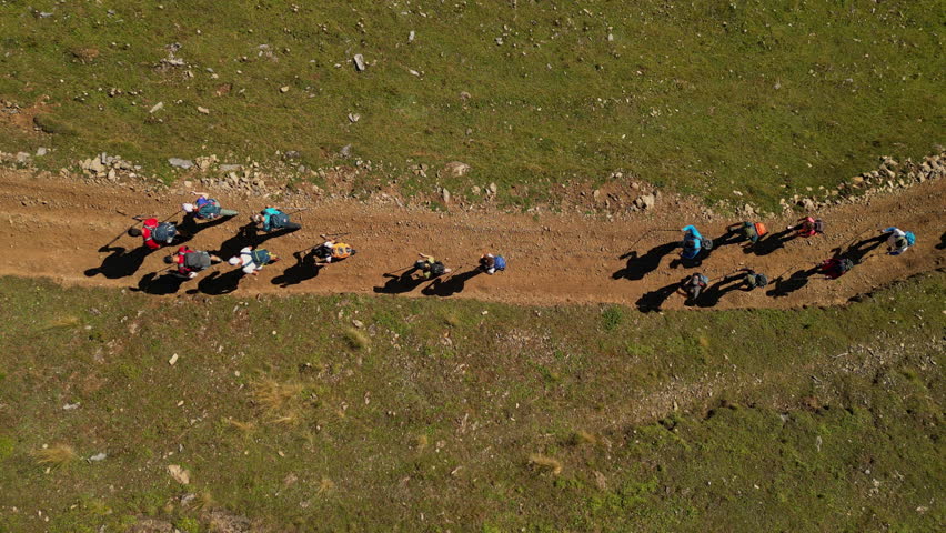 Birds Eye View of a Group of People Backpacking on a Trail Path. Concept of healthy lifestyle, vacation activity, recreational pursuit, hiking, trekking, hobby