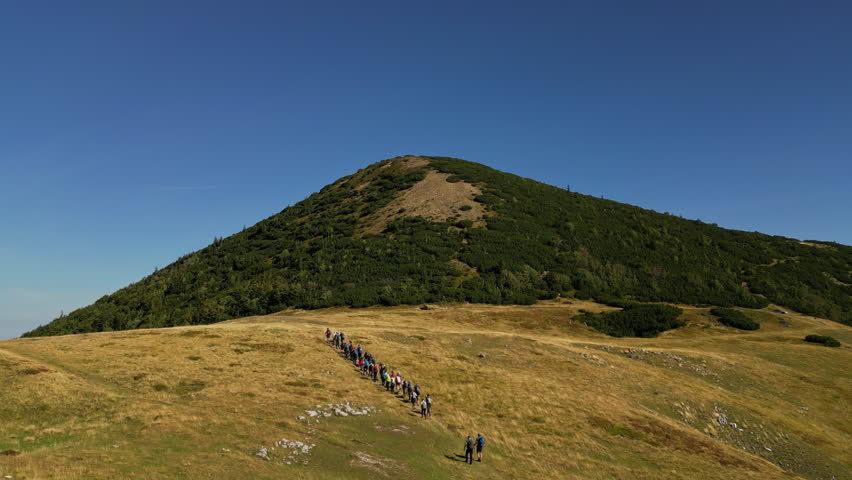 Drone Shot of a Group of People Hiking on a Trail Path. Concept of healthy lifestyle, vacation activity, recreational pursuit, backpacking, trekking, hobby