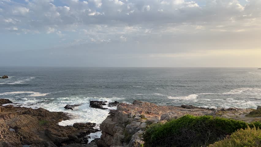 Sunset whale coast of Hermanus with views of whales close to the jagged rocky shores Royalty-Free Stock Footage #3463925527