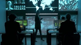 Technical support team in control room. IT specialists at the security office, big digital screen shows surveillance monitoring infographic network data. - Powered by Shutterstock - Get 15% off with code: PIKWIZARD15