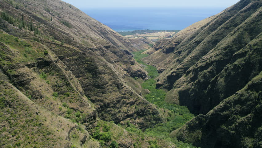 Aerial view of volcanic cliffs green tropical rainforest landscape Iao valley State Park Maui Polynesia USA RED WEAPON