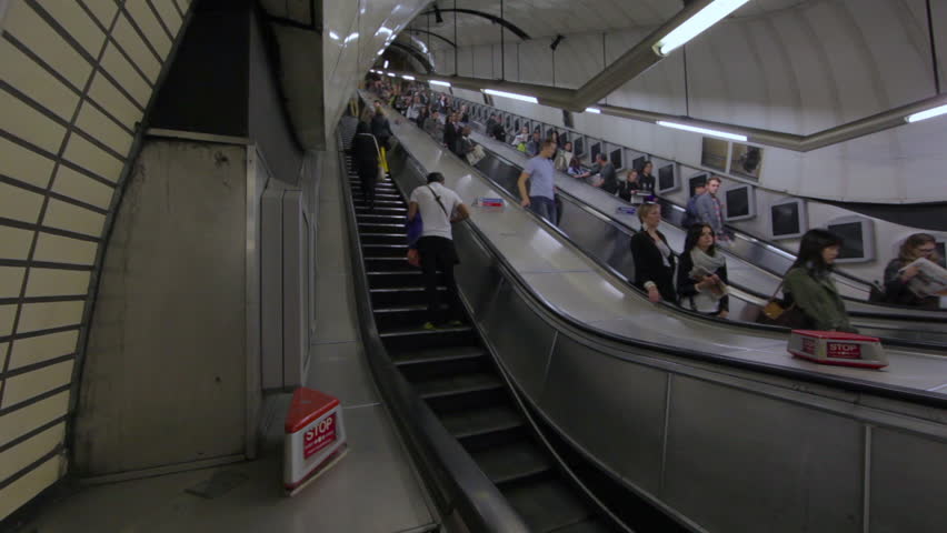 LONDON - OCTOBER 6, 2011: Escalators at Soho Station during rush hour