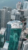 White high-rise buildings with glass facades. Aerial view of downtown Miami. Vertical video.