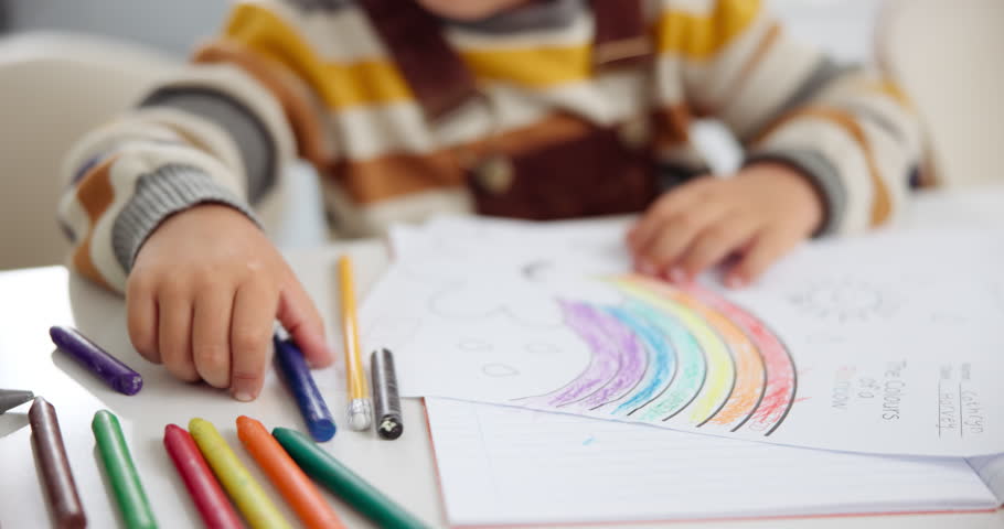 Children, coloring and crayons for art creativity or learning development in home as student, school or rainbow. Kid, hand and drawing picture on paper for homework activity or lesson, skill or youth