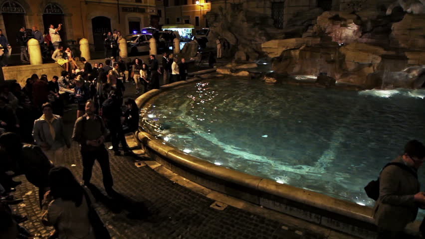 ROME - CIRCA MAY 2012: Tourists gather around the illuminated Trevi Fountain at