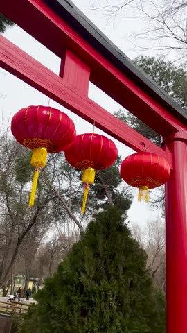 Bridge with Red Lanterns on Chinese New Year Day, blessing on the lanterns means wealth and happiness. Vertical