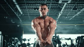 A muscular bodybuilder with hands on his waist displays his broad and sculpted back muscles, emphasizing the results of his intense muscle-building regimen. Camera 8K RAW.  - Powered by Shutterstock - Get 15% off with code: PIKWIZARD15