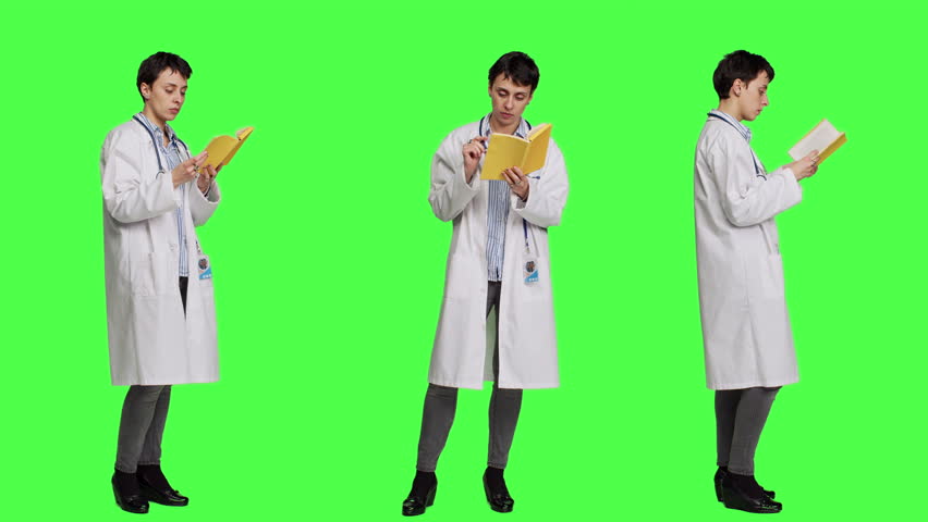 Medic specialist reading a healthcare literature book to develop her medical expertise in the industry, stands against greenscreen backdrop. Clever doctor in white coat enjoys lecture. Camera A. Royalty-Free Stock Footage #3464129411