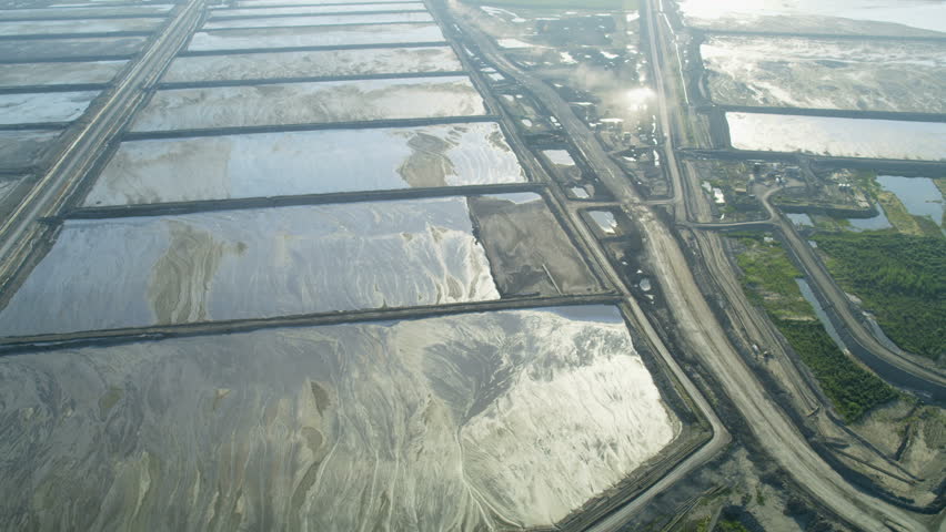 Aerial view of Athabasca oil sands which consist of a surface tailings pond a reservoir mixture of dissolved chemicals Alberta Canada RED WEAPON