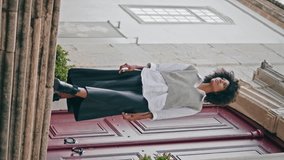 Girl walking down stairs cozy city cloudy day vertical video. Curly stylish african american woman enjoy calm stroll on staircase alone. Active fashionable brunette going downstairs exploring town. - Powered by Shutterstock - Get 15% off with code: PIKWIZARD15