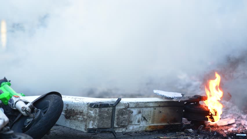 Electric scooter caught fire in the smoky city center - Close shot