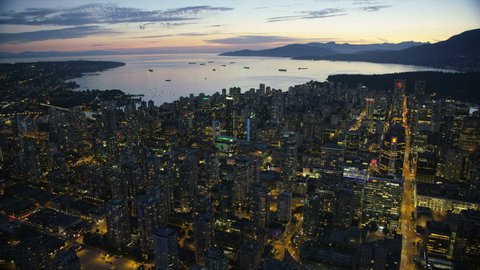 Vancouver Canada - Sept 2017: Aerial night view illuminated lights downtown Vancouver to container ships anchored English Bay Burrard Inlet British Columbia Canada RED WEAPON