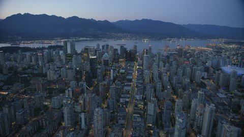 Vancouver Canada - Sept 2017: Aerial dusk view illuminated evening lights downtown Vancouver city and harbour to North Shore Mountains British Columbia Canada RED WEAPON