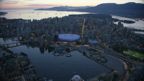 Aerial dusk view Vancouver city BC Place Edgewater Casino and North Shore Mountains Burrard Inlet British Columbia Canada RED WEAPON