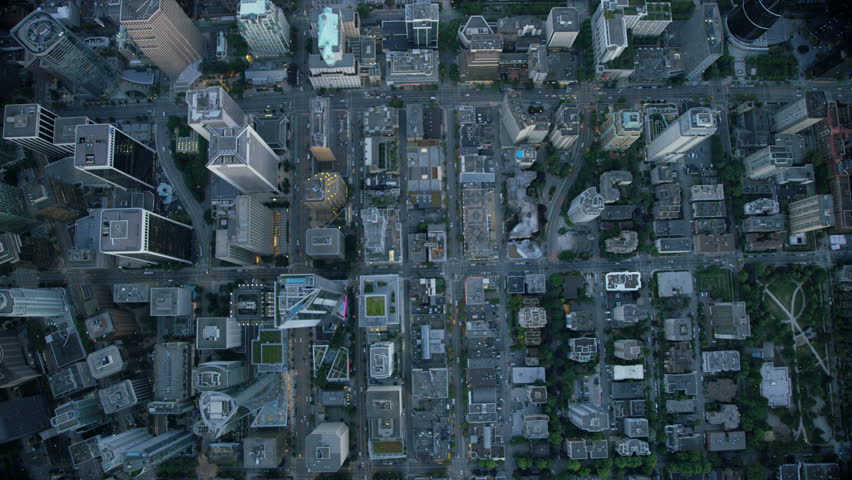 Aerial overhead view downtown Vancouver office skyscrapers and commuter vehicles traveling on city streets British Columbia Canada RED WEAPON