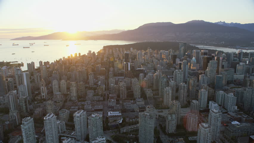 Vancouver Canada - Sept 2017: Aerial overhead view downtown Vancouver skyscrapers Stanley Park English Bay and Burrard Inlet bridges at sunset British Columbia Canada RED WEAPON