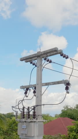 Power transformer mounted on pole in southeast asian. Vertical video. Royalty-Free Stock Footage #3464265755