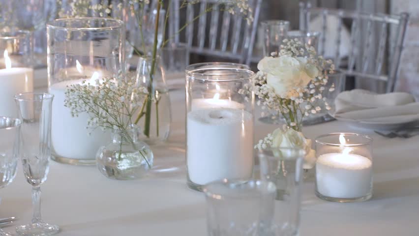 Bulk candles made of granulated wax and white decorative flowers in Provence style for celebrating a wedding reception Royalty-Free Stock Footage #3464299327
