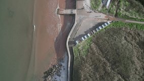 Broadsands, Torbay, South Devon, England: DRONE VIEWS: Overhead view of beach huts; sea; Broadsands sandy beach with people and dogs. Torbay is a popular UK holiday resort (Clip 3).