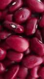 Background of red kidney beans rotating close up. Vertical video.