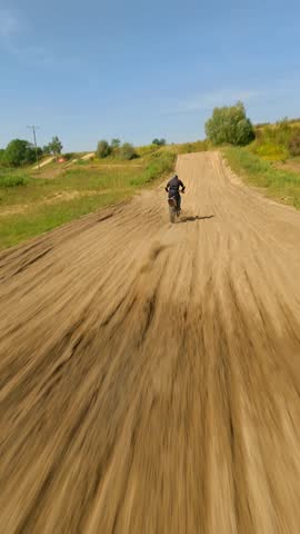 Aerial view of extreme motocross bike jump in slow motion. Concepts of extreme sports, racing, and adrenaline.