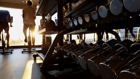 Close up of feet on exercise bike with sunset sky background. Taken from hand. High quality FullHD footage