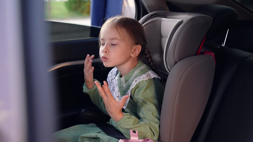 girl daughter dances sings child seat car. happy family. children's safety road. Traffic Laws. cheerful happy girl daughter kid child. fasten your seat belt in the car. back leather seat in the car.