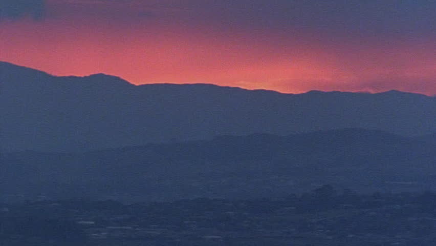 Sunlight over blue hills