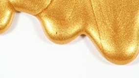 Liquid Gold Motion On The White Background. Macro Shot of Glitter Fluid Metallic Yellow Color Paint. Natural Organic Cosmetics, Medicine. Production Close-up. Slow Motion - Powered by Shutterstock - Get 15% off with code: PIKWIZARD15