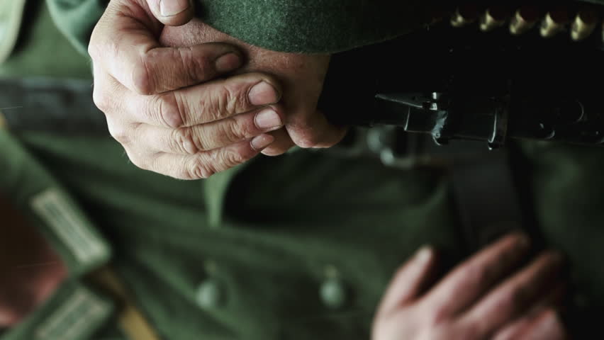 Close Up View On Hands Of Re-enactor Dressed As German Wehrmacht Machine Gunner Infantry Soldier In World War Ii. German Soldier Uniform. German Soldier