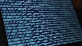 Bit and Bytes. Binary Code running down on the laptop screen, illuminated in blue. Big data, zero and one, digital, sequence, program, software, binary string, science and technology. - Powered by Shutterstock - Get 15% off with code: PIKWIZARD15