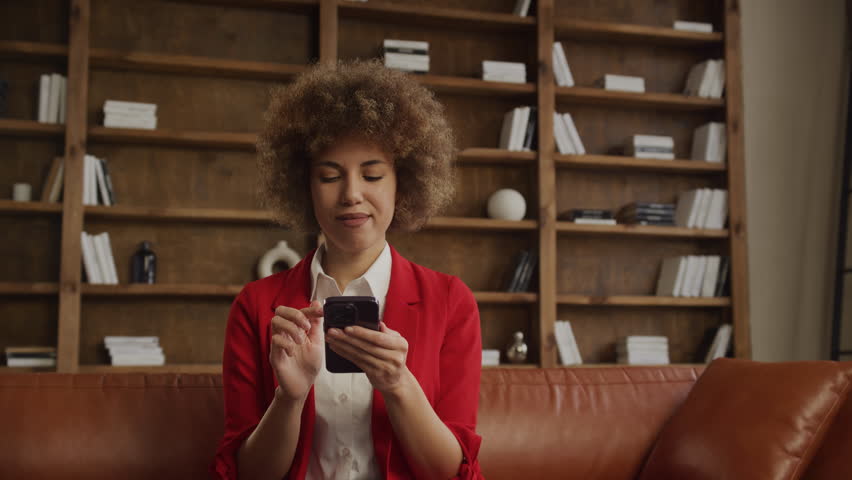 Confused Businesswoman Using Smartphone in Office Royalty-Free Stock Footage #3464498067