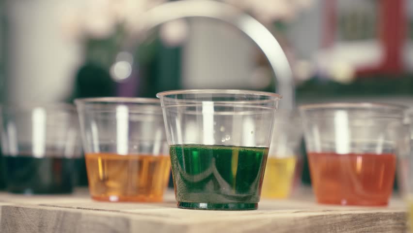 Happy Boy coloring easter eggs in a kitchen