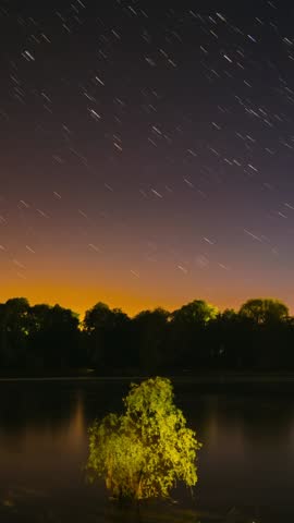 Timelapse Night Sky Above River. Star Lines Move In Sky. Star Trails On Night Sky Background. Amazing Starry Effects. From Dusk To Dawn. Night Sky Turns Into Morning. Dawn Is Coming. Time Lapse Time