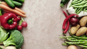 Vegetables frame background with copy space for a text. Healthy food, fresh vegetables set on a kitchen stone desk. Stock footage vertical video 4k