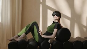 Female in modern VR glasses in futuristic home. Augmented reality game, future technology, AI concept. AR. 