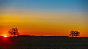 Sunrise To Morning Timelapse - Sun Rising Over The Countryside Field. - wide shot - Powered by Shutterstock - Get 15% off with code: PIKWIZARD15