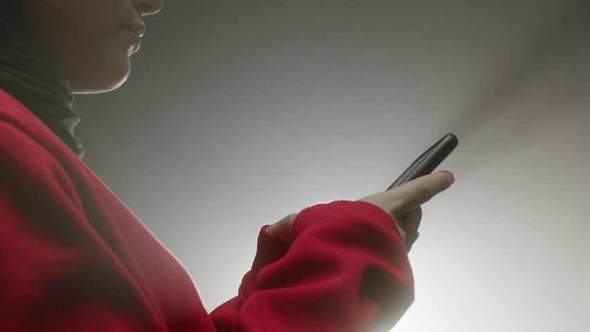 Young girl in hijab playing with mobile phone girl child in hijab