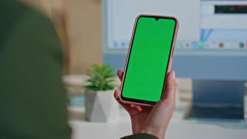 Manager reading message at chroma key cellphone sitting work desk close up. Unrecognizable woman browsing online application on green screen smartphone at office. Girl hand holding mockup mobile phone - Powered by Shutterstock - Get 15% off with code: PIKWIZARD15