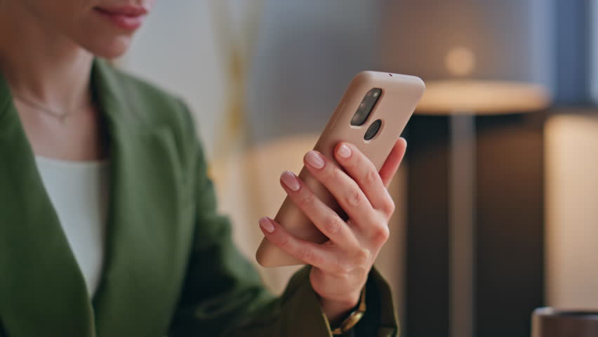 Woman hands scrolling mobile phone sitting modern office closeup. Unknown confident businesswoman using smartphone for solving business tasks. Anonymous elegant lady boss swiping telephone screen 